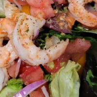 Grilled Shrimp Salad · Grilled shrimp on top of salad  Made of mixed greens and iceberg lettuce. Topped with onions...