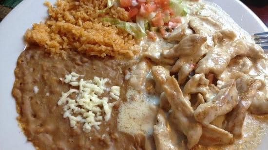 Pollo Con Crema. · Tender chicken strips cooked with green peppers and onions in authentic Mexican sour cream sauce served with rice, beans and tortillas.