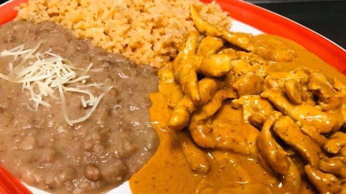 Pollo Chipotle · Sliced chicken breast, zucchini, onions, cooked in a creamy chipotle sauce served with rice and beans, and tortillas.