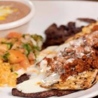 Cazuelon · Grilled chicken topped with thin slicedangus steak, chorizo mexican sausage and melted chees...