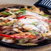 Cheezy Fajitas · Your choice of meat cooked to perfection with onions and bell peppers smothered with Oaxaca ...
