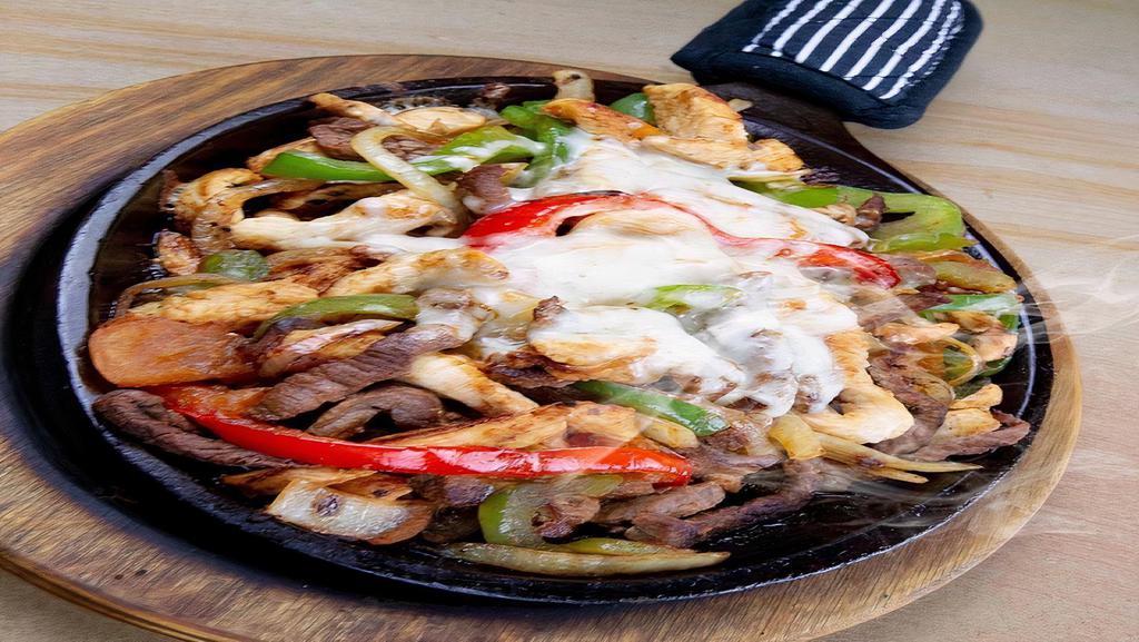 Cheezy Fajitas · Your choice of meat cooked to perfection with onions and bell peppers smothered with Oaxaca cheese. Served with rice, beans, sour cream, and salad.