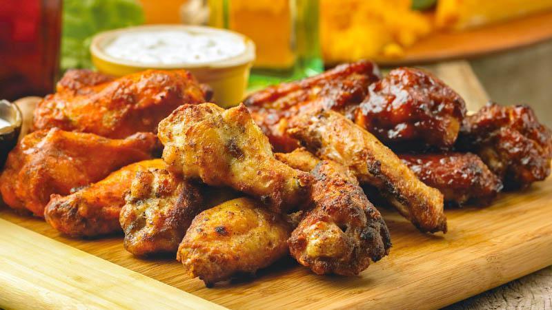 Chicken Wings · Tender, juicy wings served flaming hot or smoky barbeque with your choice of creamy ranch or chunky bleu cheese dressing.