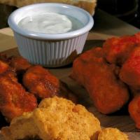 Boneless Bites · Tender, juicy chicken, served plain, shaken in buffalo or BBQ sauce, with choice of dressing.