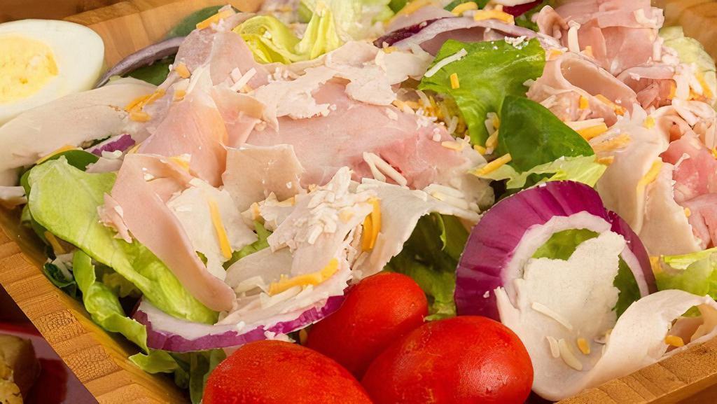 Chef Salad · Iceberg, romaine & spinach,  chopped ham & turkey, eggs, cheddar cheese, red onions & grape tomatoes. Served with hot garlic bread.