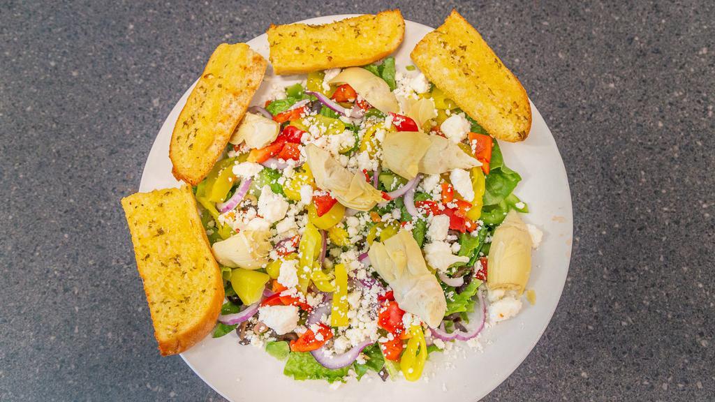 Mediterranean Salad · Romaine topped with red& green pepper, black & green olive, artichoke, red onion, banana peppers & feta cheese. Served with hot garlic bread.
