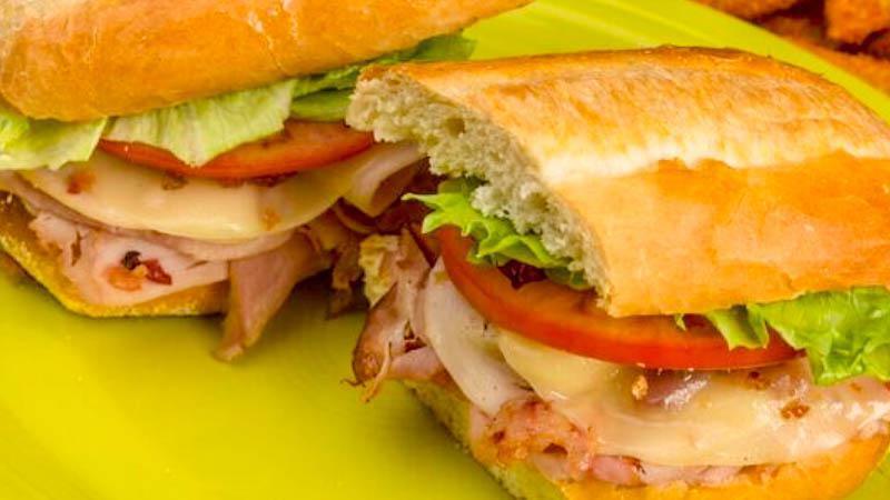 Turkey Club · Sliced ham & turkey, bacon, melted provolone, topped with lettuce & tomato. Served with honey mustard dressing.
