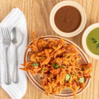 Onion Pakoda · Sliced onion mixed with chickpeas flour and indian spices & fried until golden brown.