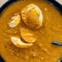 Anda Curry · Boiled eggs cooked with homemade mild tangy gravy.