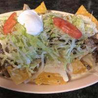 Nachos With Your Choice Of Meat · Served with your choice of meat, sour cream, lettuce, tomatoes and cheese.