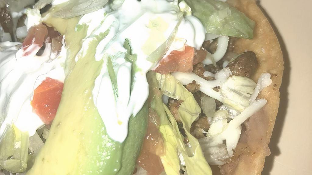 Huaraches · Topped with your choice of meat, sour cream, beans, lettuce, tomato, avocado, and cheese.