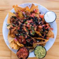 Nachos Grande · Tortilla chips smothered in melted cheese, onions, sour cream, jalapeños, diced tomatoes, an...