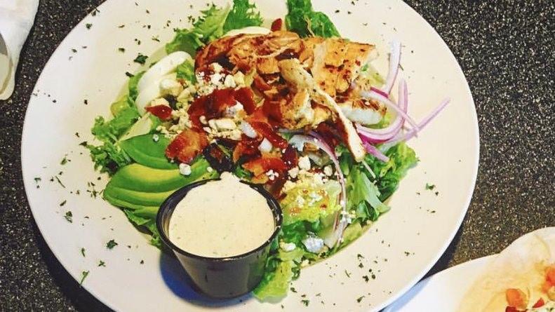 Cobb Salad · Romaine lettuce, grilled chicken, crispy bacon, avocado, egg, red onion, bleu cheese crumbles, and choice of dressing.