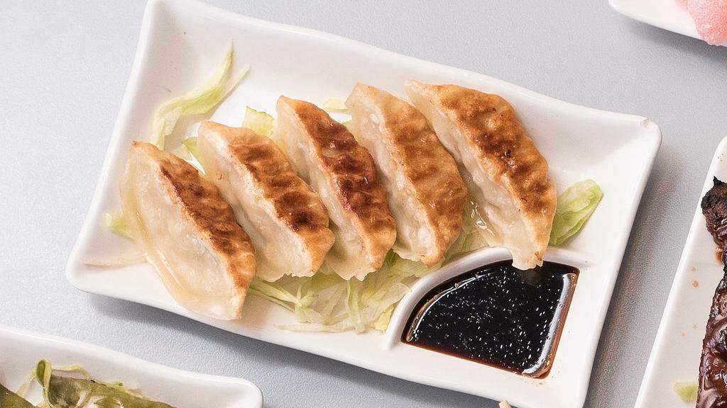 Gyoza Dumpling · Six pieces stuffed vegetable and pork Japanese dumpling pan-fried or steamed and served with garlic sesame soy sauce.