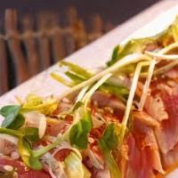 Tuna Tataki · Lightly seared tuna in thin slices served with ponzu sauce. Rare.