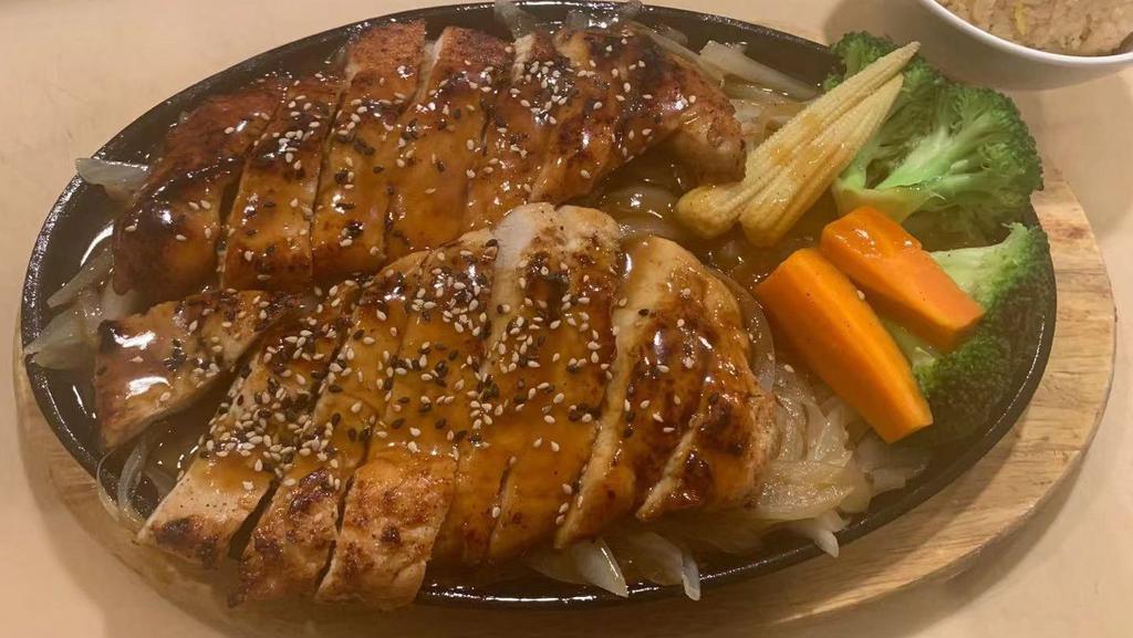 Teriyaki Chicken · Grilled chicken on a bed of grilled onion topped with house teriyaki sauce. Served with soup or salad and steamed or fried rice.
