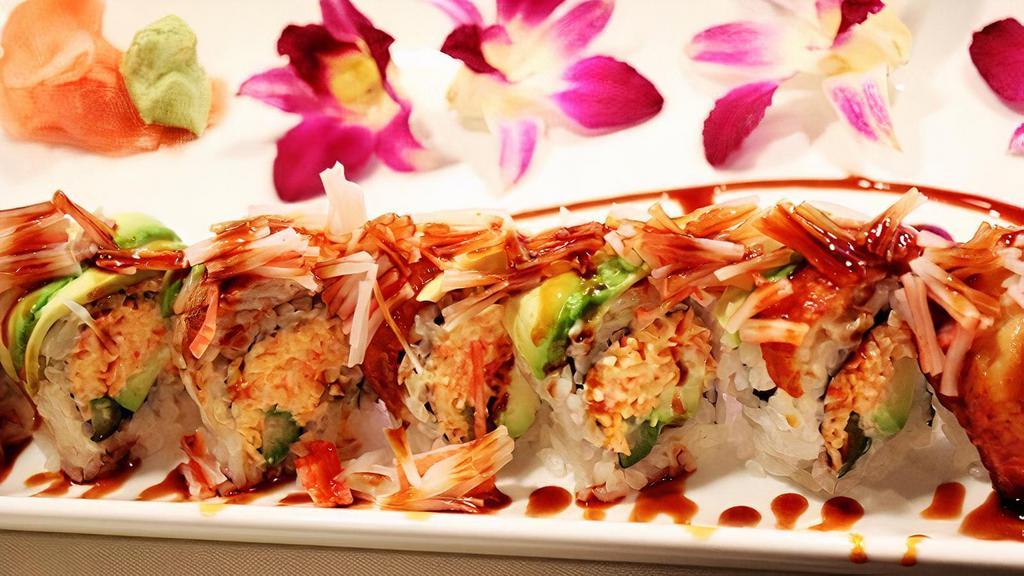 Dragon Roll · Snow crab, avocado, and asparagus inside. Broiled eel, avocado, eel sauce, crab sticks, and sesame seed on top.