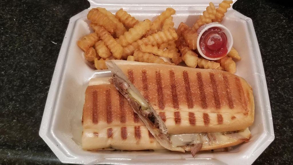 Cubano Sandwich · Roasted pork and ham smothered in cheese with mayonnaise, mustard, and pickles. Served with French fries or a house salad.