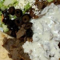 Gyros Mix Plate · Gyros and chicken tenders a top rice pilaf, your choice of Greek, tabouli salad and pita bre...