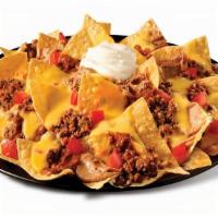 Beef Mucho Nachos · Chips, beef, chili sauce, beans, queso, tomato, sour cream.
