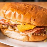Torta Cubana · Mexican Style Sandwich with Choice meat, Ham & Eggs with Lettuce & Tomatoes.