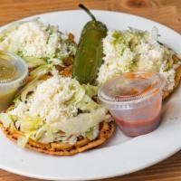 Sopes · Refried beans, lettuce, queso fresco, sour cream served with red & green sauce.