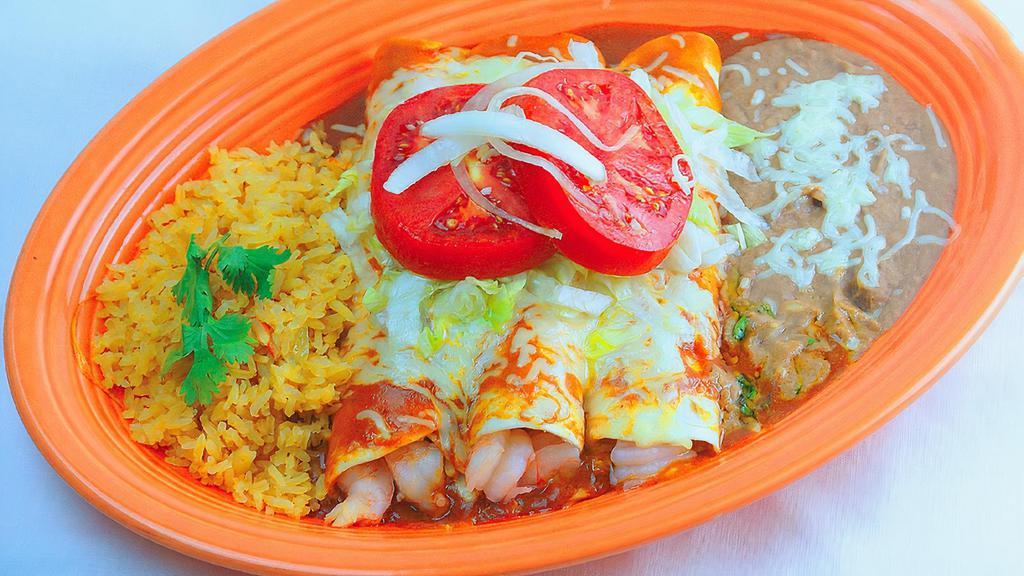 Pacifico Enchiladas · Three Enchiladas stuffed with cooked shrimp and imitation crab, topped with enchilada sauce, lettuce, tomatoes, and onions. Served with rice and beans.