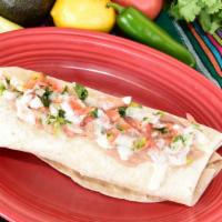 Chilaquile Chicken Burrito · Our crispy tortilla chips, grilled chicken with spicy tomatillo sauce and then stuffed into ...