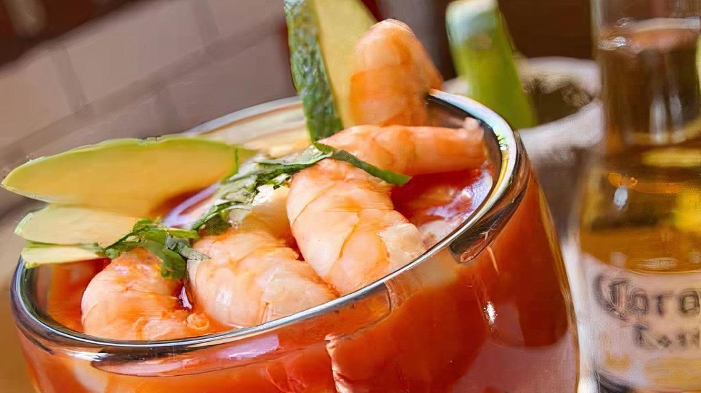 Shrimp Cocktail · Shrimp served with sliced onions, cilantro, tomatoes, peppers, and avocado mixed with our special sauce.