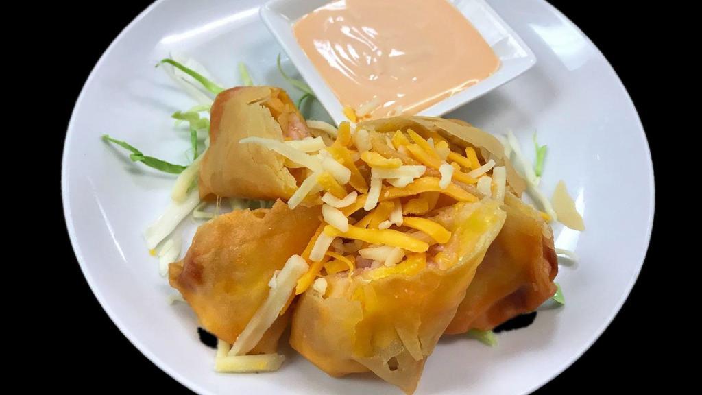 Crispy Bacon · Bacon and cheese wrapped in spring roll skin, deep fried. Served with a special creamy white sauce.