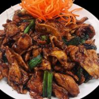 Mongolian Chicken · Stir-fried chicken with onions and scallions served in a sweet brown sauce on top of crispy ...