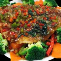 Basil Fish · Crispy tilapia filet served over steamed vegetables in a spicy brown sauce.