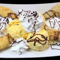 Fried Bananas · Tempura style bananas served with vanilla ice cream. Decorated with chocolate syrup, whipped...