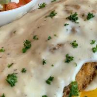 Chicken Fried Chicken · Buttermilk fried chicken breast and mashed potatoes topped with gravy with side salad.
