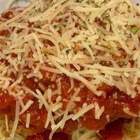 Chicken Parmesan · Buttermilk fried chicken breast topped with melted parmesan and marinara over angel hair pas...