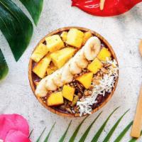 Surf’S Up Tropical Bowl · Acai bowl topped with granola, bananas, pineapple, mango, shredded coconut, and honey.