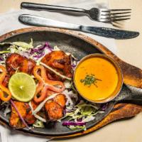 Tandoori Chicken · Gluten-free. Spicy. Chicken marinated in spices with yogurt and slow-cooked in clay oven.