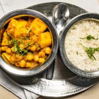 Chana Masala · Vegan. Gluten-free. Chickpeas cooked with onions, herbs, and spices. Served with choice of r...