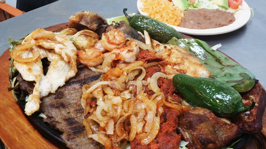-Super Parrilada For 2 Person · Pork ribs, steak chicken breast, shrimp, carnitas, Mexican sausage(chorizo), two different onions, served with rice, beans, salad, guacamole, fried jalapeno, nopal, sour cream and pico de gallo.