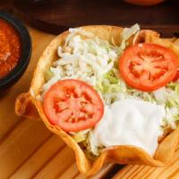Taco Salad · The salad is served with a fried flour tortilla shell stuffed 
with rice, beans, shredded ic...