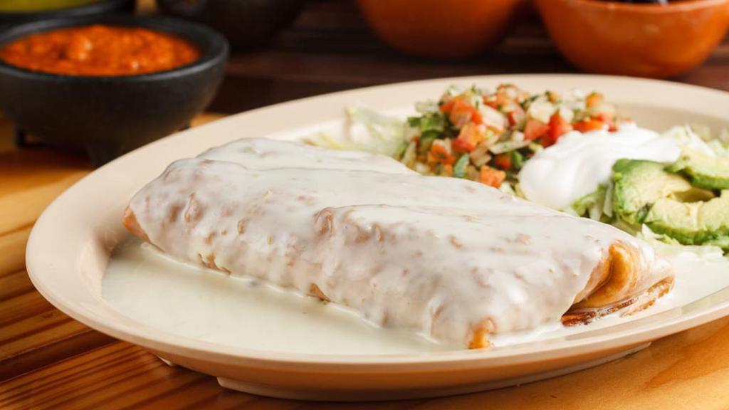 Chimichanga · A large flour tortilla filled with shredded chicken, refried beans, cheese, salsa and spices, rolled up like a burrito and covered in cheese dip.