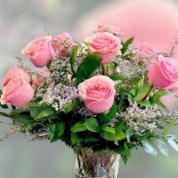 1 Dozen Pink Roses · A stunning vase filled with pink rose, greenery and seasonal fillers will be delivered.