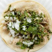Street Taco · Beer-braised pork, onions, cilantro, lime.