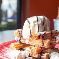 Churros · Fried pastry tossed in cinnamon, piled high!  Vanilla ice cream, chocolate sauce, Mexican sy...
