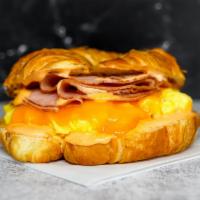 Croissant, Ham, Egg, & Cheese Sandwich · 2 scrambled eggs, melted cheese, sliced ham, and Sriracha aioli on a warm croissant.