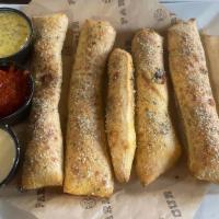 Garlic Breadsticks · Served with house-made garlic butter, red sauce and white cheese sauce.