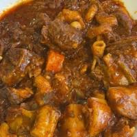 Goat Stew  · Goat cubes cooked and  well marinated tomato sauce, with macaroni, Potatoes and carrots  ser...