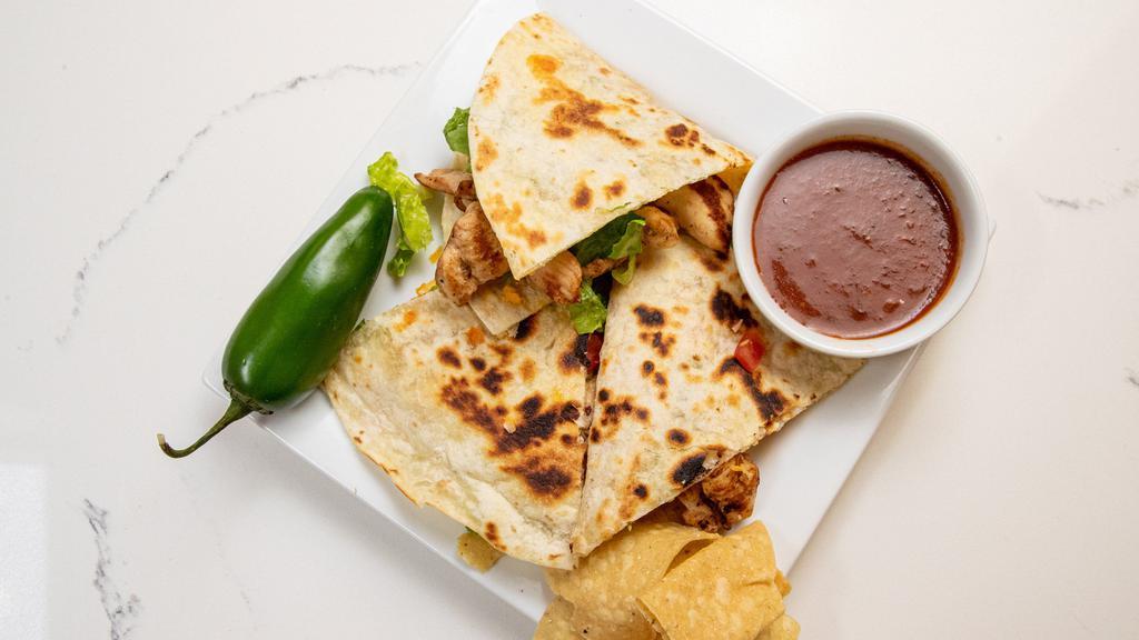 Quesadilla · Golden brown grilled tortillas with queso medley, choice of filling, lettuce, tomatoes and sour cream. Served with rice, tortilla chips, salsa fresca and your choice of beans.