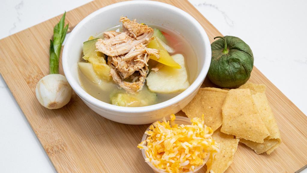 Tortilla Soup · Topped with cheddar cheese, tender chicken, veggies and crisps tortillas.