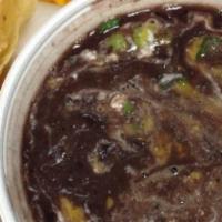 Black Bean Soup · Topped with cheddar cheese, tangy sour cream and fresh green onions.